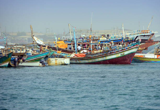 Massawa, Northern Red Sea Region, Eritrea: traditional fishing boats with the Gherar peninsula in the background - richly decorate sambuk boats, at type of dhow, mainly sailed on the East African, Arabian and Indian coasts - Edaga district, Gulf of Zula / Annesley Bay / Baia di Arafali, Red Sea.