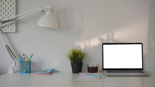istock Home office desk with computer laptop, coffee cup, notebook, plant and pencil holder. 1311766908