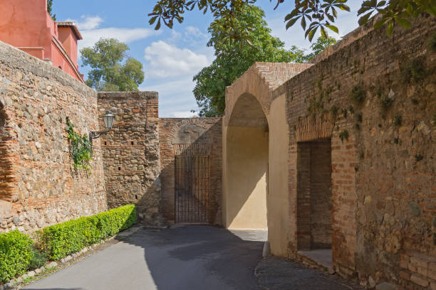 istock Old street between two brick and stone fences 1311767822