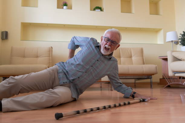 istock An Older Man with Walking Cane is Lying on the Floor After an Accident he had. 1311768072