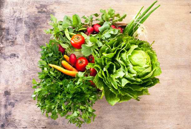 istock Vegetable heap on wooden background. 1311778879