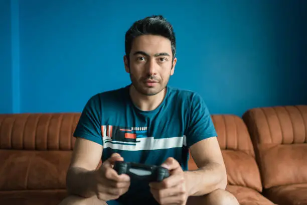 Photo of men having party indoors fun playing sports game on console