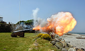 Cannon firing and showing the plume of smoke and fire , North Wales Coast, Wales, UK