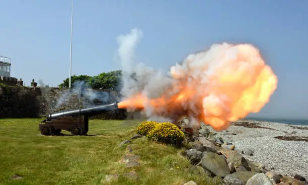 Photo of Cannon firing and showing the plume of smoke and fire , North Wales Coast, Wales, UK