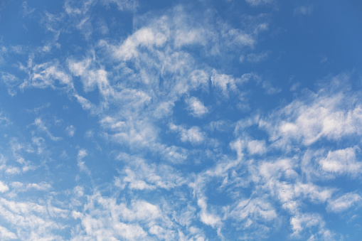 Fluffy cirrus clouds at blue sky