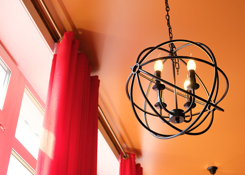 Modern chandelier . Black Metal Hanging Lights.  cutting edge ceiling Light Round shape. Design of home, warm light from shades.