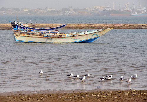 Massawa, Northern Red Sea Region, Eritrea: pier and traditional fishing boats with the Gherar peninsula in the background - Edaga district, Gulf of Zula / Annesley Bay / Baia di Arafali, Red Sea.
