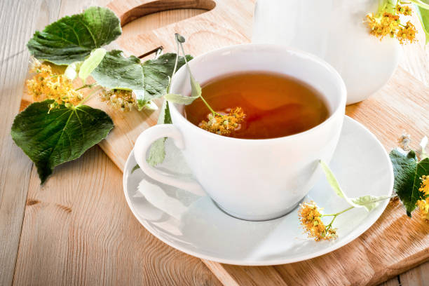 istock Lime tea on a wooden table with leaves 1311783304