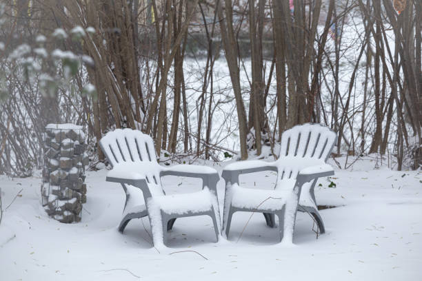 Garden with chairs covered with fresh snow