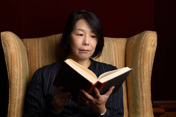 istock Woman sitting down with a hardcover book 1311789789