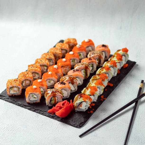 Feng Shui roll, Kani Hot Sushi Roll Feng Shui roll, Kani Hot Sushi Roll with Philadelphia roll close up sushi plate stock pictures, royalty-free photos & images