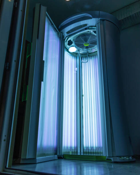 Standing empty solarium Standing empty solarium with blue light tanning bed stock pictures, royalty-free photos & images