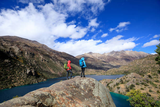istock Two women backpackers hiking  in beautiful winter mountains 1311791020