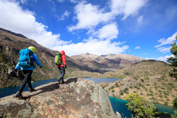 istock Two women backpackers hiking  in beautiful winter mountains 1311791252