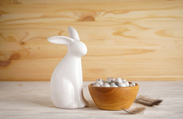 istock Easter bunny and Easter eggs in a bowl on a wooden background. Place for text 1311791320