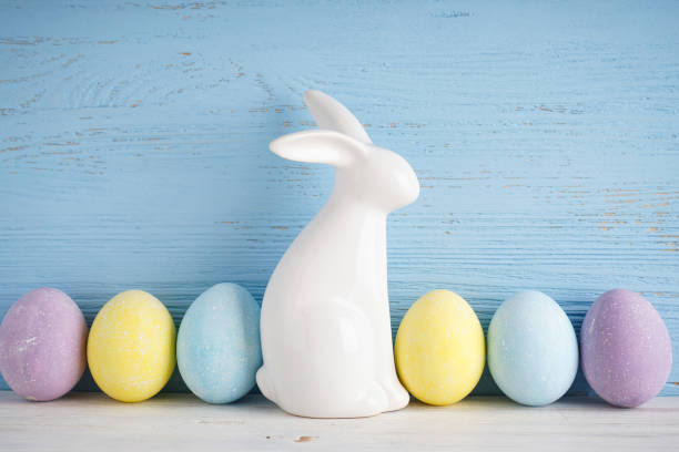 istock Easter bunny and colorful eggs on a wooden background. 1311791475