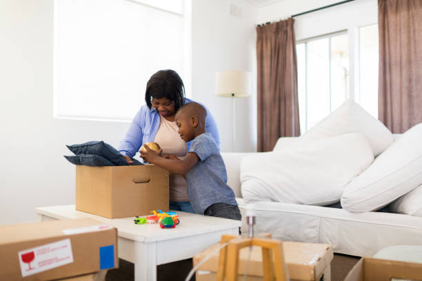 istock Son helps mother unpack boxes in new home 1311792772