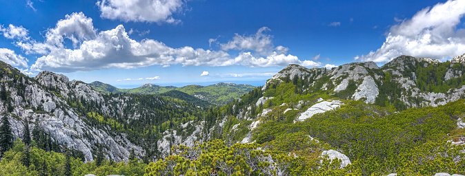 Large panorama showing mountain peaks in the Northern Velebit National Park, Croatia. UNESCO World Heritage Site. The Northern Velebit National Park is recognizable by its preserved biodiversity, richness of the natural phenomena and experience of pristine wilderness.