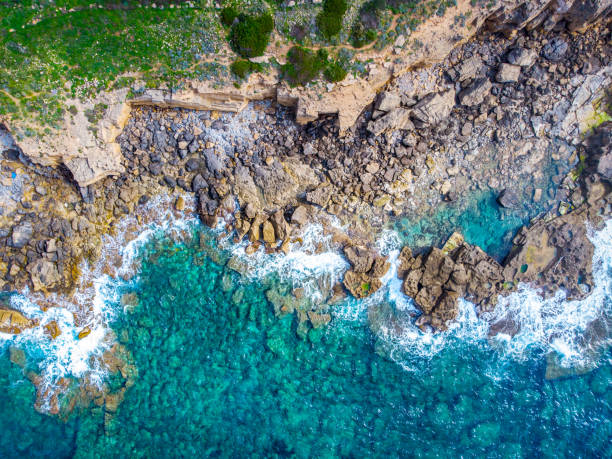 istock Turquoise sea by Alghero rocky shoreline seen from above 1311793968