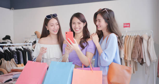 istock three women look at smartphone 1311797595