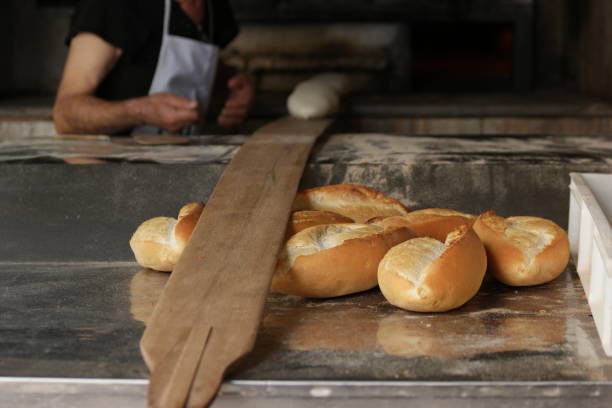 istock Fresh white bread from the oven. Food production concept. 1311797656