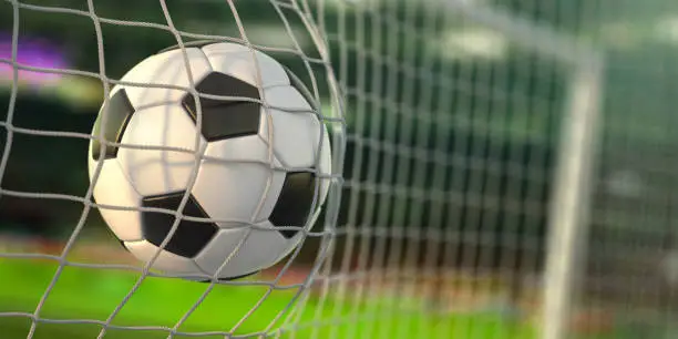Photo of Goal. Soccer football ball scores a goal on the net.