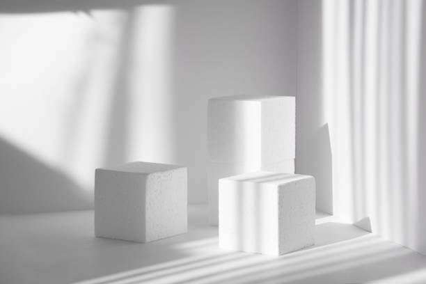 istock 3d podium, for presentations of packaging and cosmetics. Three white styrofoam cubes, of different heights, against background of clean walls, shadow from the harsh sunlight like streaks 1311801376