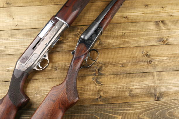 istock hunting rifles on a wooden background 1311803224