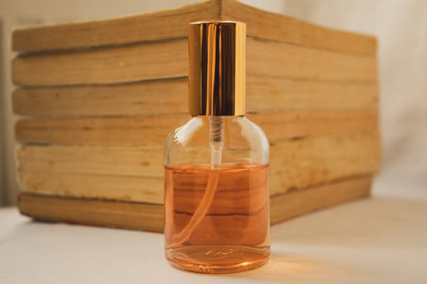 istock Orange little perfume on old books background 1311805624