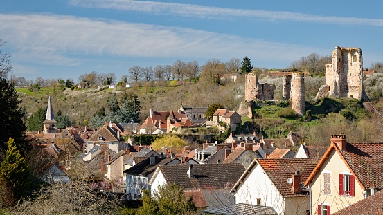 An overlooking view of the old village of Herisson in the french region of Auvergne, which is nested in a valley and dominated by the ruins of a castle