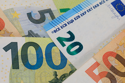 There are European Union banknotes next to each other. Euro banknotes are not made of paper, but of pure cotton fiber to improve their durability.