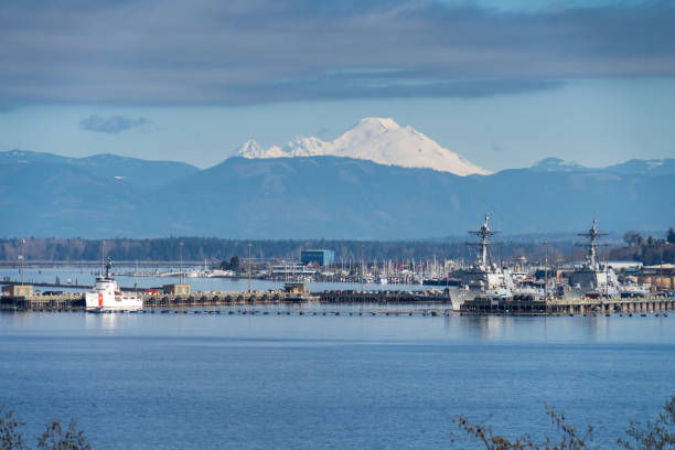Naval and Cost Gard Boats with Mt Baker in the Background Everett WA. USA - 04-05-2021: Naval Station Everett (NAVSTA Everett) - shows Naval and Cost Gard Boats with Mt Baker in the Background everett washington state stock pictures, royalty-free photos & images