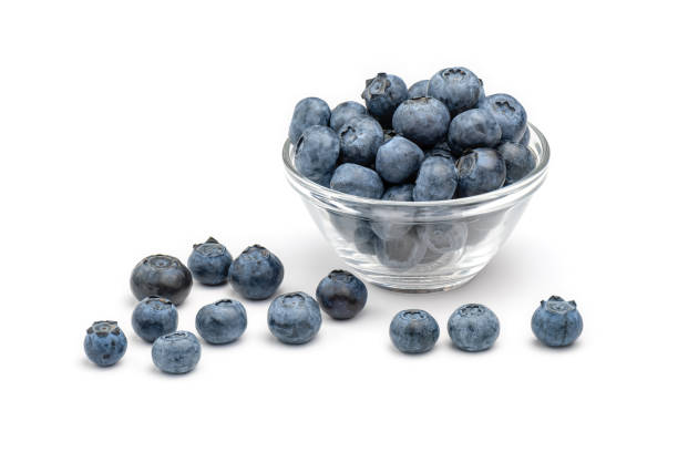 istock Fresh blueberries in glass bowl isolated on white background. 1311813055
