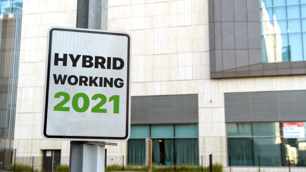 istock Hybrid working 2021 sign in a downtown city setting 1311815420