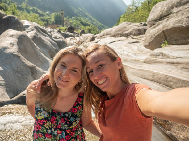 istock Two young women taking selfie by the river in Spring 1311816149