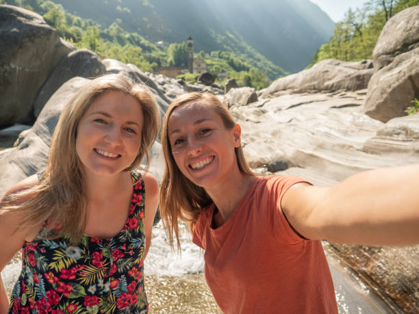 istock Two young women taking selfie by the river in Spring 1311816190