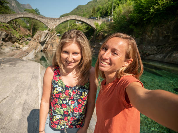 istock Two young women taking selfie by the river in Spring 1311816356