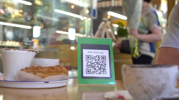 istock QR code touch-free payment display in the restaurant. To use a QR code payment the consumers scans the QR code displayed by the merchant with their phones to pay for their goods. Shopping 1311816393