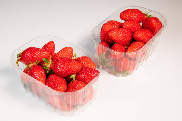 istock Punnet of strawberries isolated on white background 1311817390