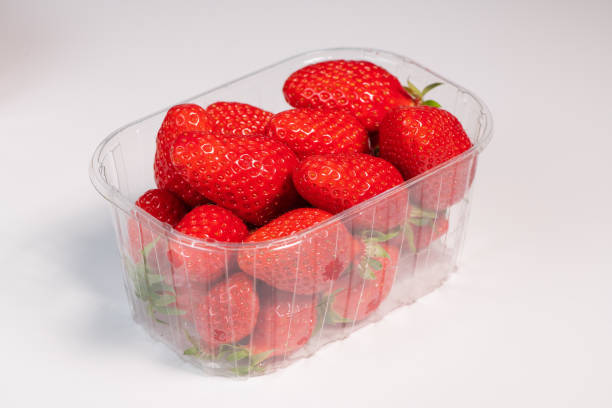 istock Punnet of strawberries isolated on white background 1311817570