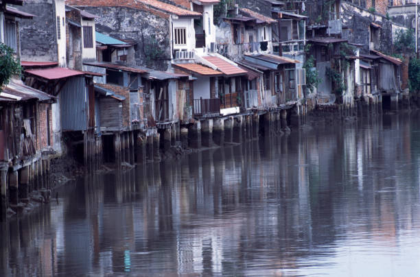 istock Wooden houses in Melaka reflected in a river 1311818901