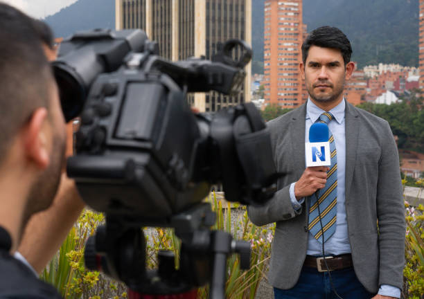 istock Journalist in front of the camera reporting breaking news 1311819063