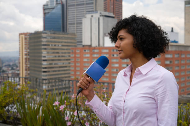 istock Profile of a journalist outdoors reporting breaking news 1311819070