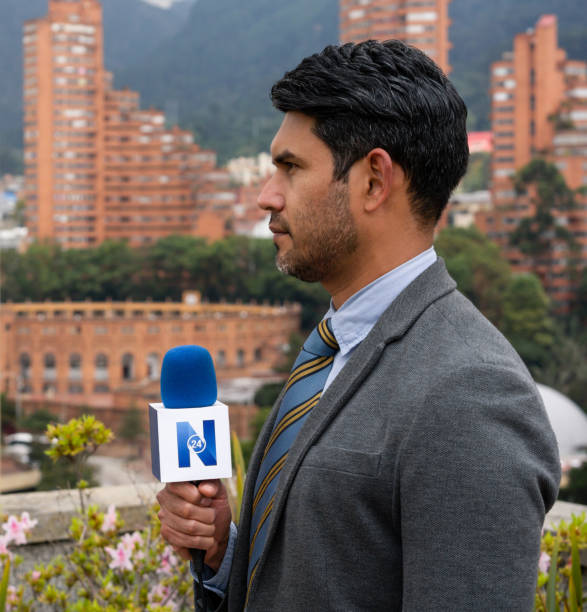 istock Profile of a journalist outdoors reporting breaking news 1311819078