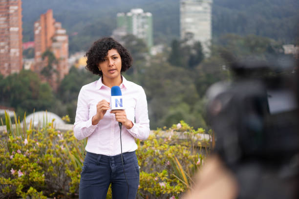 istock Newscaster in front of the camera reporting breaking news 1311819089