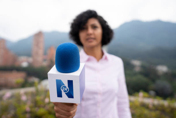 istock Tv reporter outdoors interviewing a person - POV concepts 1311819090