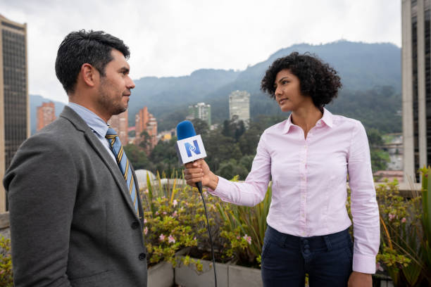 istock News reporter outdoors interviewing a politician 1311819094