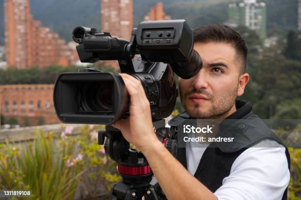 Cameraman Outdoors Recording Breaking News Stock Photo - Download Image Now - Camera Operator, Film Director, Latin American and Hispanic Ethnicity