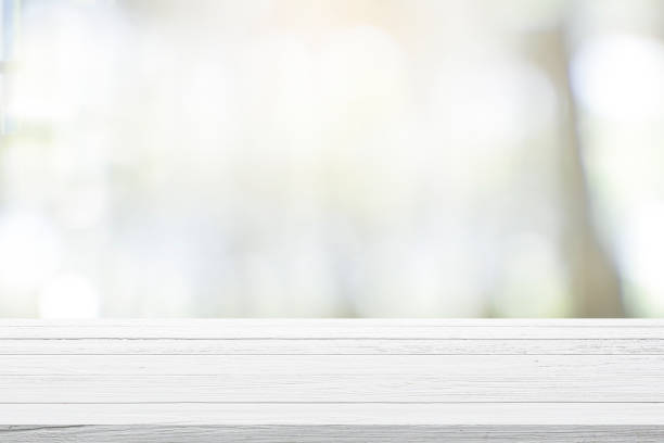 istock Empty wooden table for present product on coffee shop blur background. 1311820100
