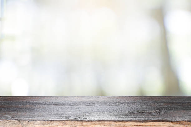 istock Empty wooden table for present product on coffee shop blur background. 1311820107